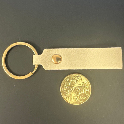 Brass keychain with leather strap and gold coin