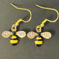 Bee-shaped earrings with gold, black, and yellow colors 