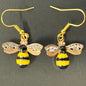 Bee-shaped earrings with gold, black, and yellow colors 