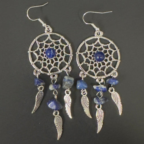 Pair of dreamcatcher earrings with blue stones on a dark background
