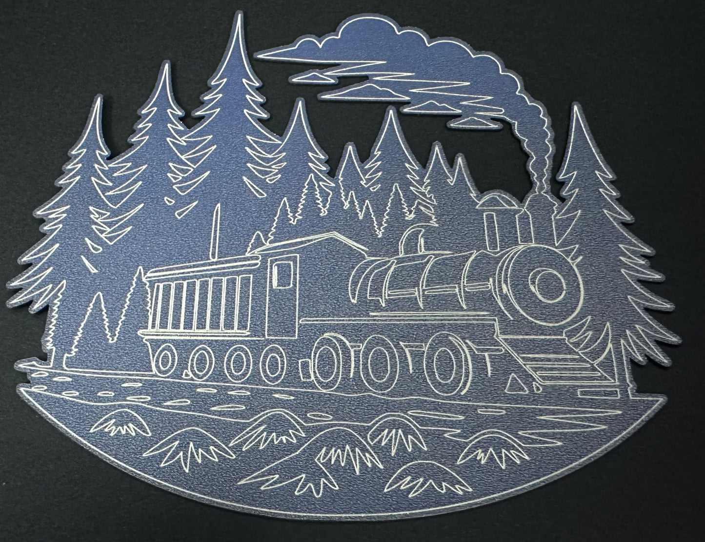 Metallic train cutout with trees and mountains on a black background