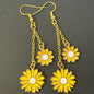 Yellow flower-shaped earrings with gold coloured chains
